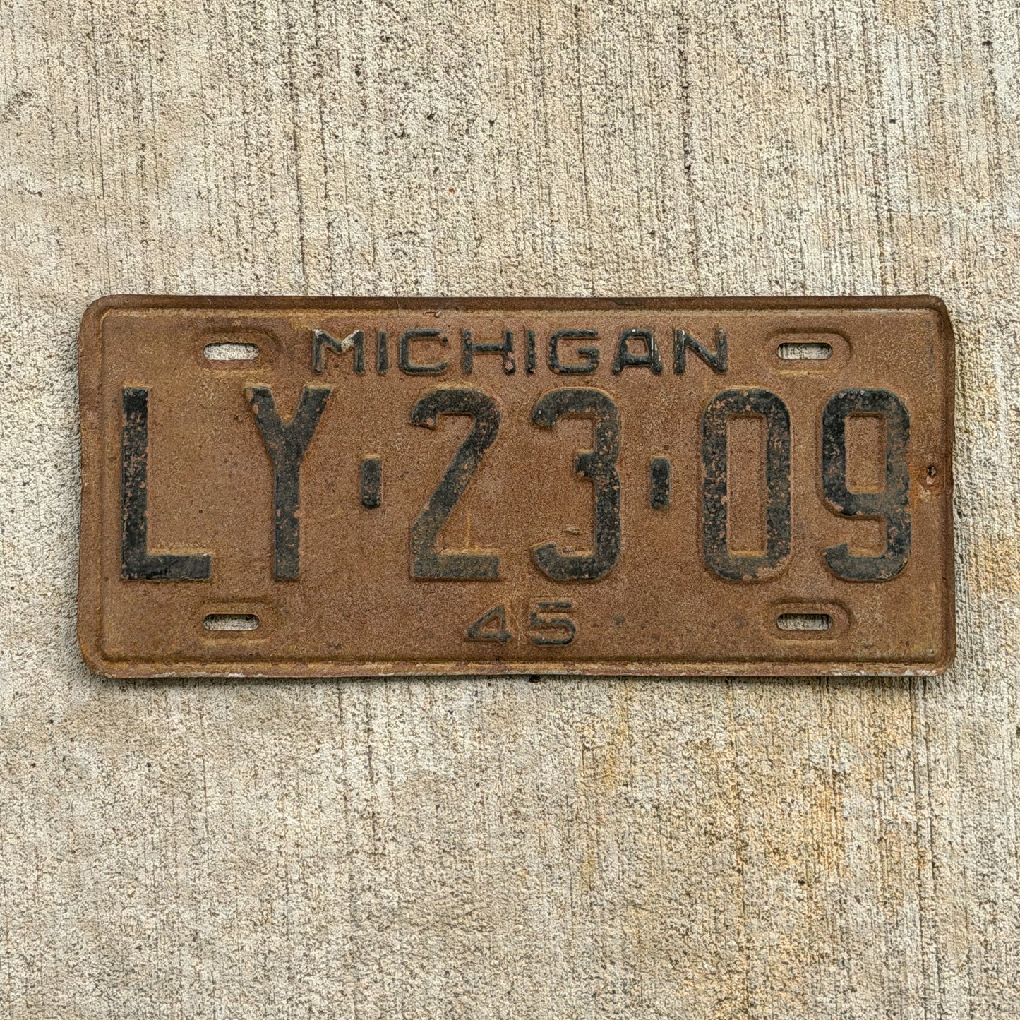 Photo of a 1945 Michigan License Plate Auto Tag Garage Decor Vintage LY 23 09 with original patina