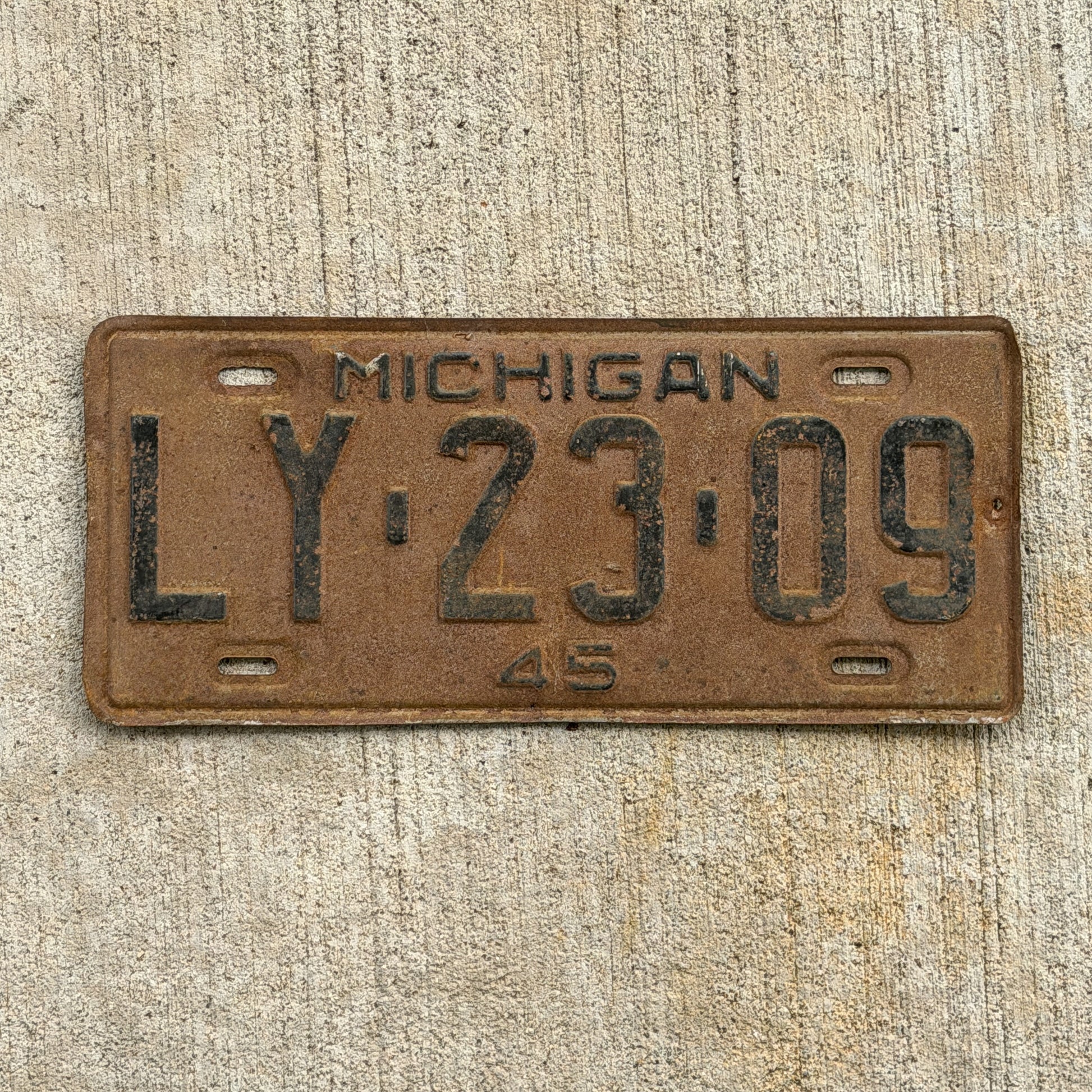 Photo of a 1945 Michigan License Plate Auto Tag Garage Decor Vintage LY 23 09 with original patina