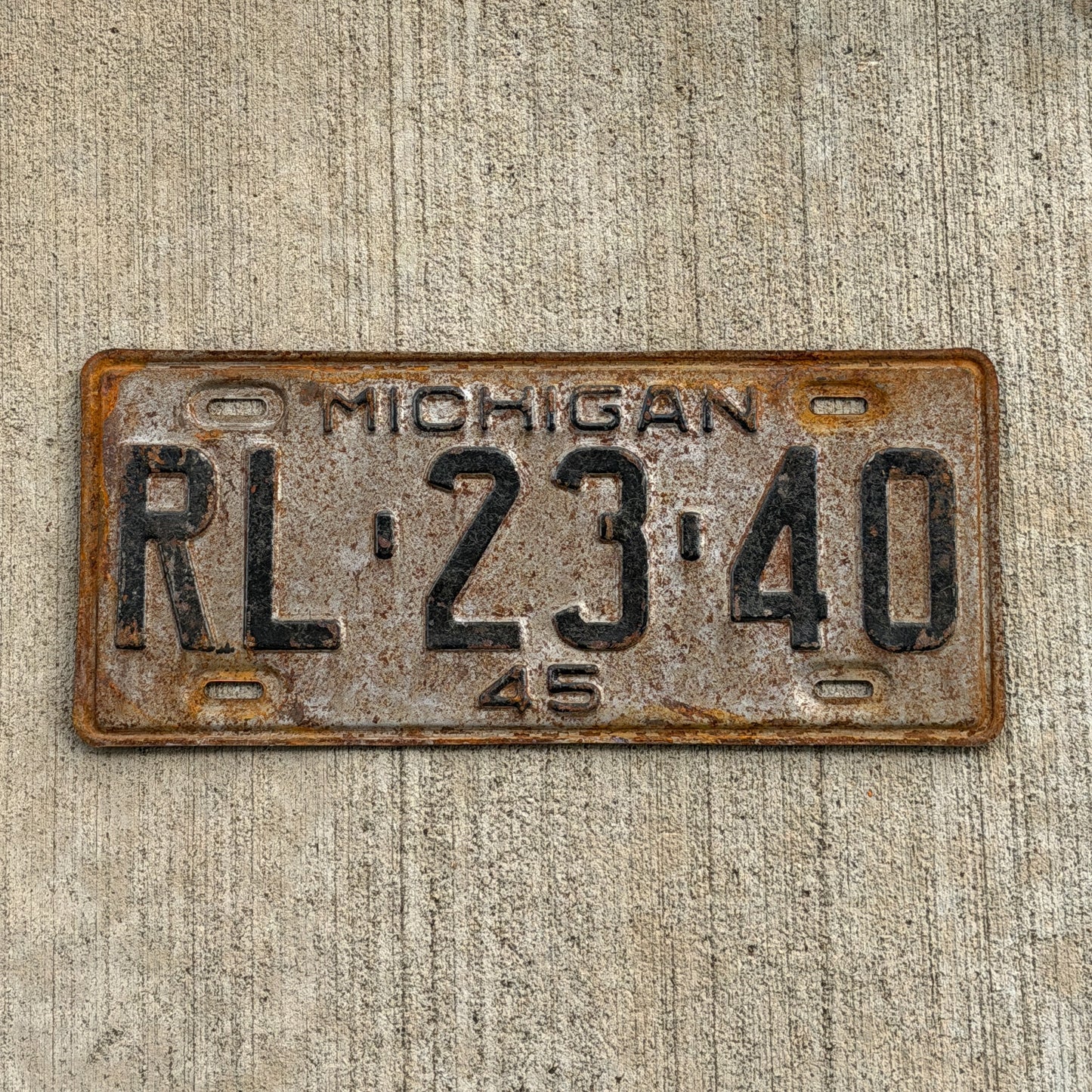 Photo of a 1945 Michigan License Plate Auto Tag Garage Decor Vintage RL 23 40 with original patina