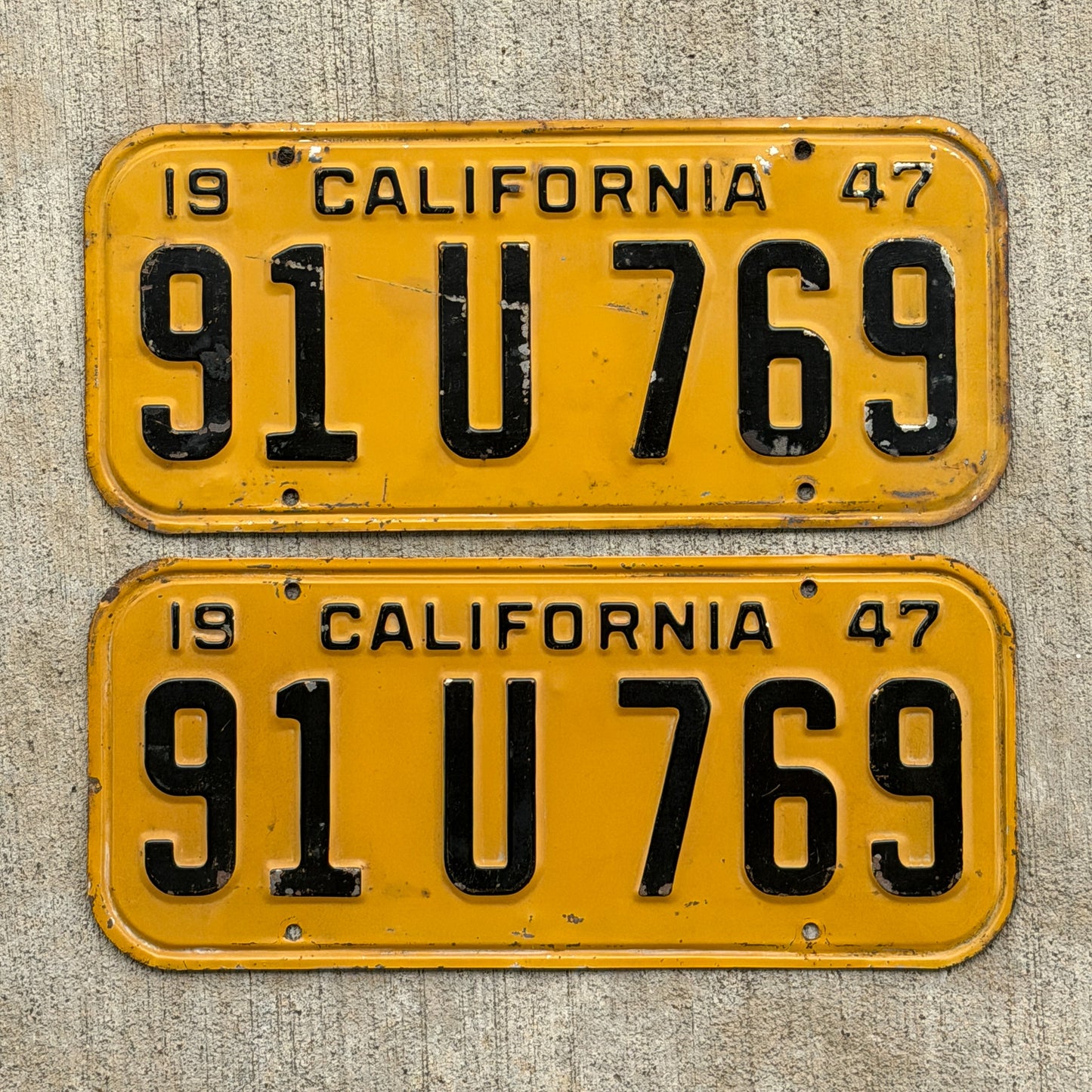 Photo of a 1947 California License Plate Pair Auto Tag Garage Decor Vintage YOM Number DMV Clear 91 U 769 with original patina