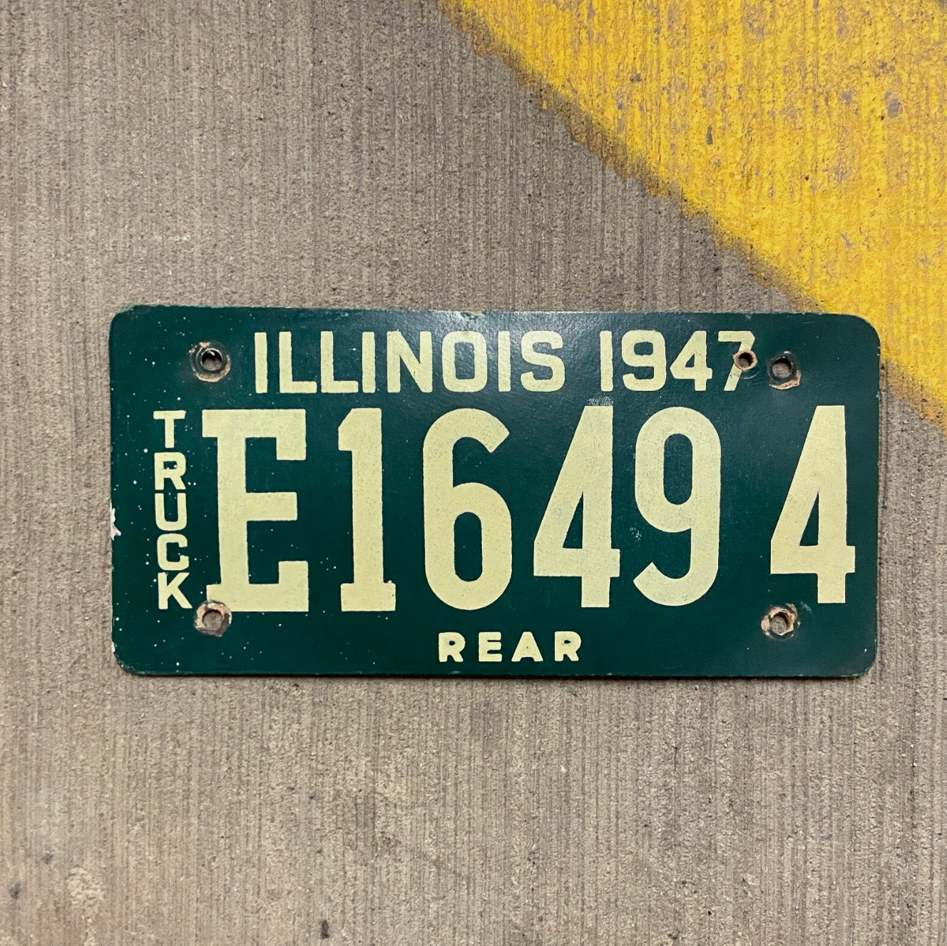 Photo of a 1947 Illinois Fiberboard Truck License Plate Auto Tag Garage Decor Vintage E 16494 with original patina