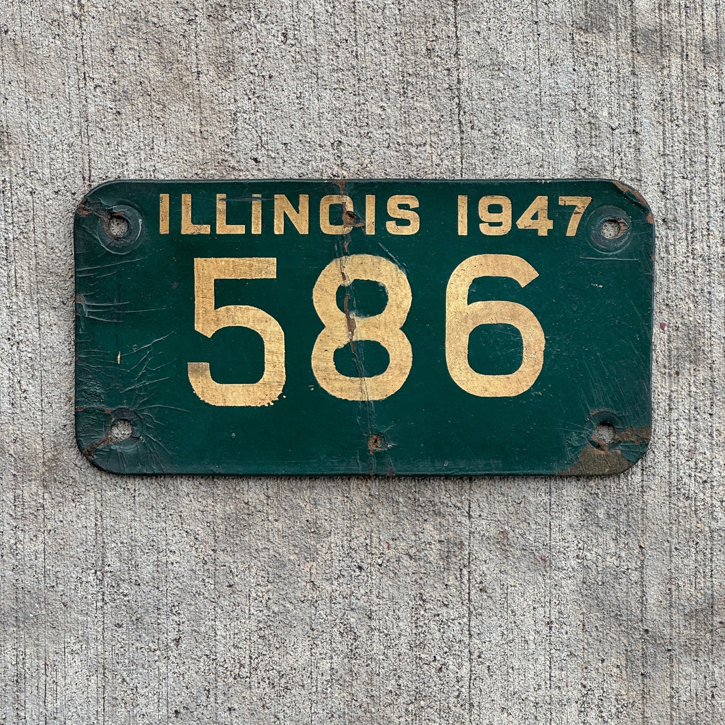 Photo of a 1947 Illinois Motorcycle License Plate Auto Tag Garage Decor Vintage Fiberboard Low Number Three Digit 586 with original patina
