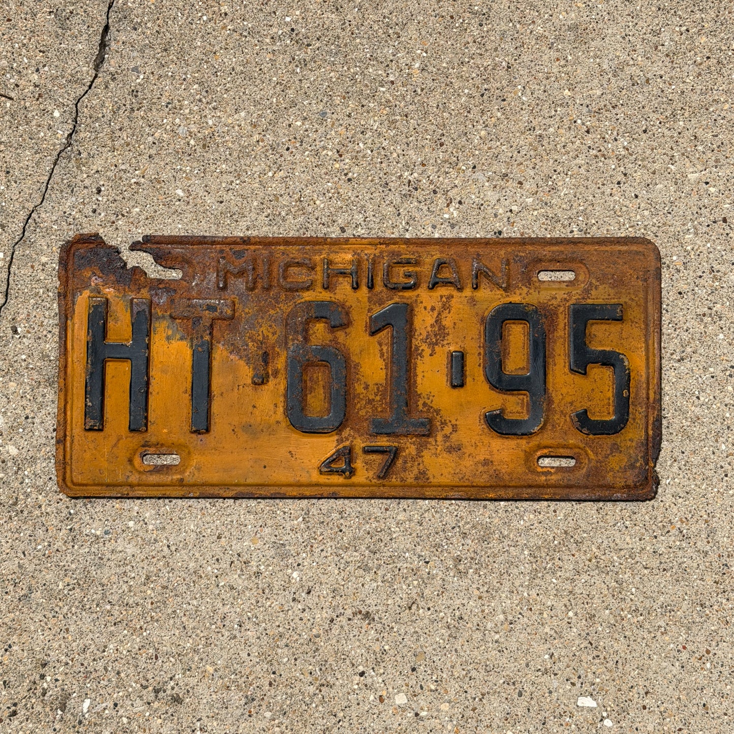 Photo of a 1947 Michigan License Plate Auto Tag Garage Decor Vintage HT 61 95 with original patina