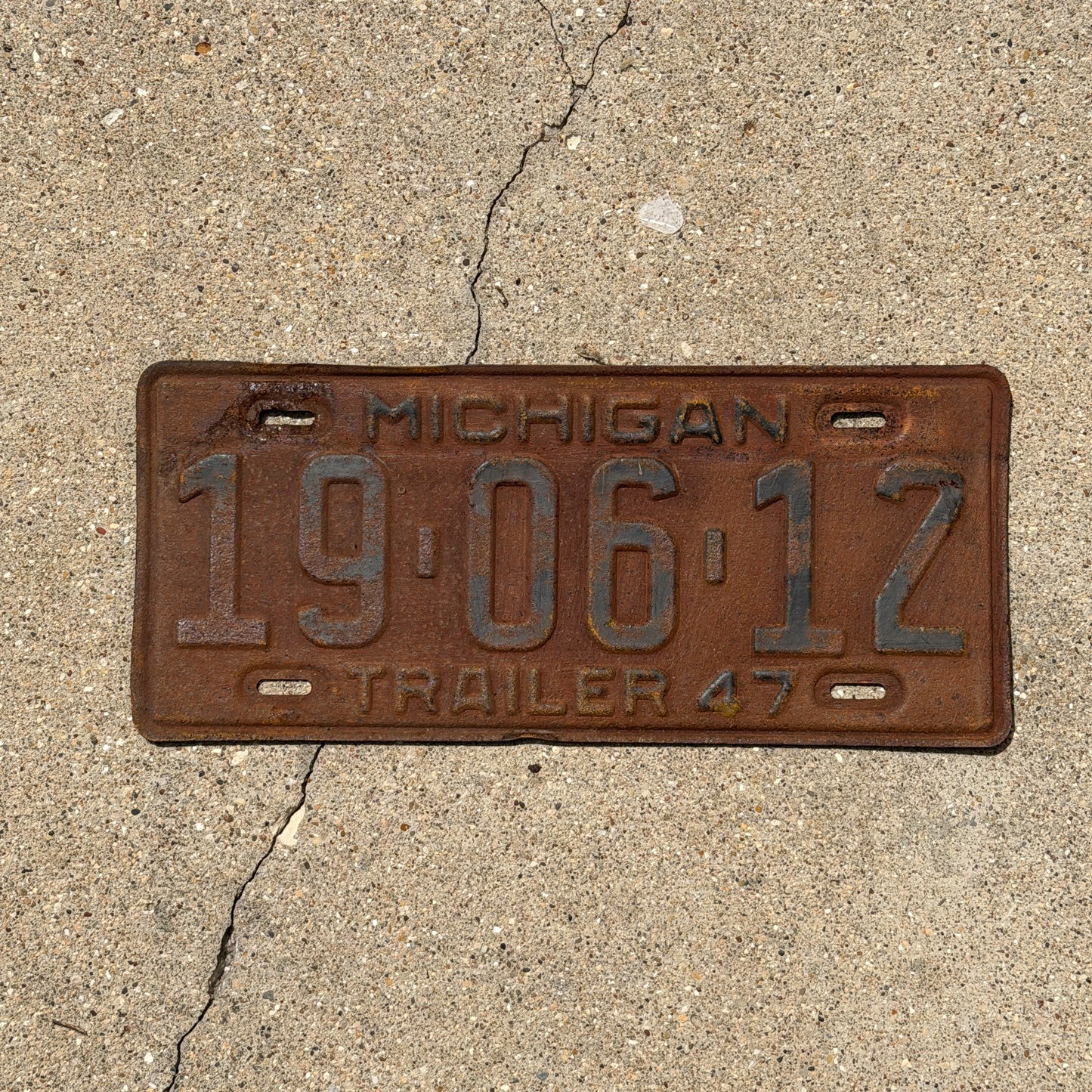 Photo of a 1947 Michigan Trailer License Plate Auto Tag Garage Decor Vintage 19 06 12 with original patina