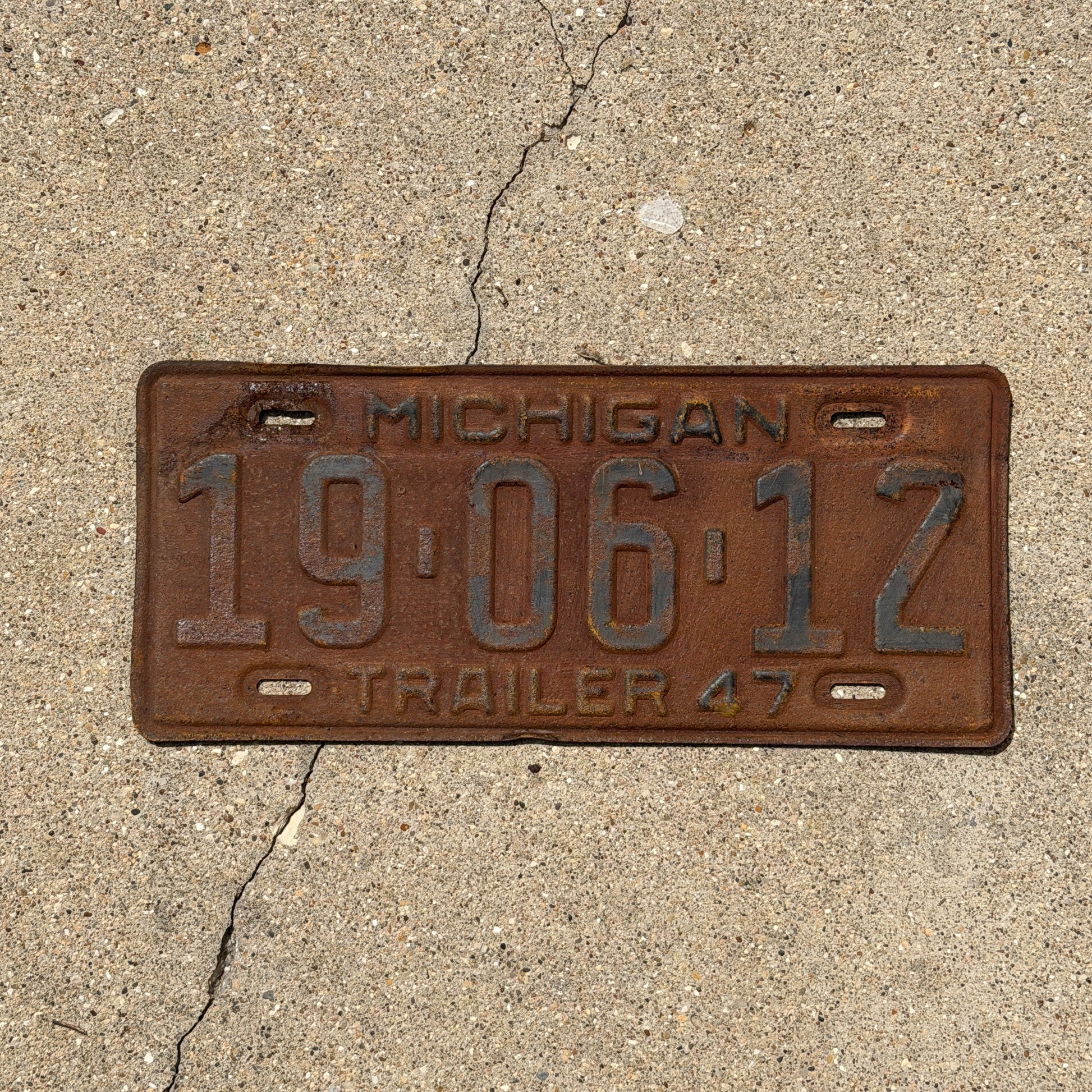 Photo of a 1947 Michigan Trailer License Plate Auto Tag Garage Decor Vintage 19 06 12 with original patina