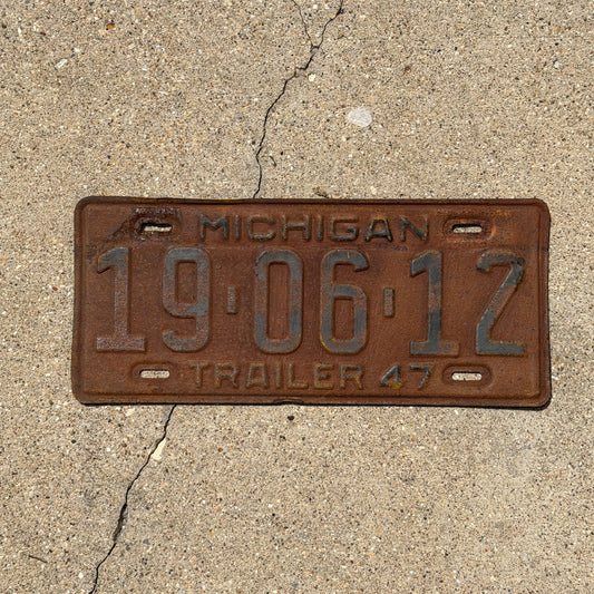 Photo of a 1947 Michigan Trailer License Plate Auto Tag Garage Decor Vintage 19 06 12 with original patina