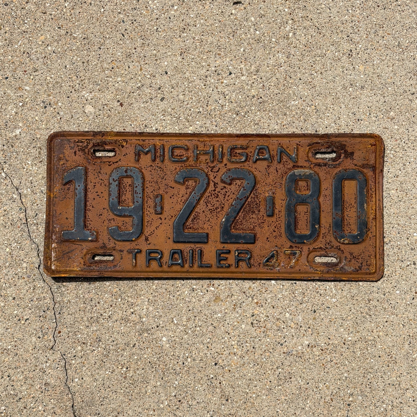 Photo of a 1947 Michigan Trailer License Plate Auto Tag Garage Decor Vintage 19 22 80 with original patina