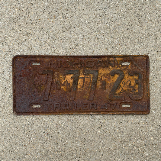 Photo of a 1947 Michigan Trailer License Plate Auto Tag Garage Decor Vintage Lucky 7 Repeat Repeating 7 77 23 with original patina