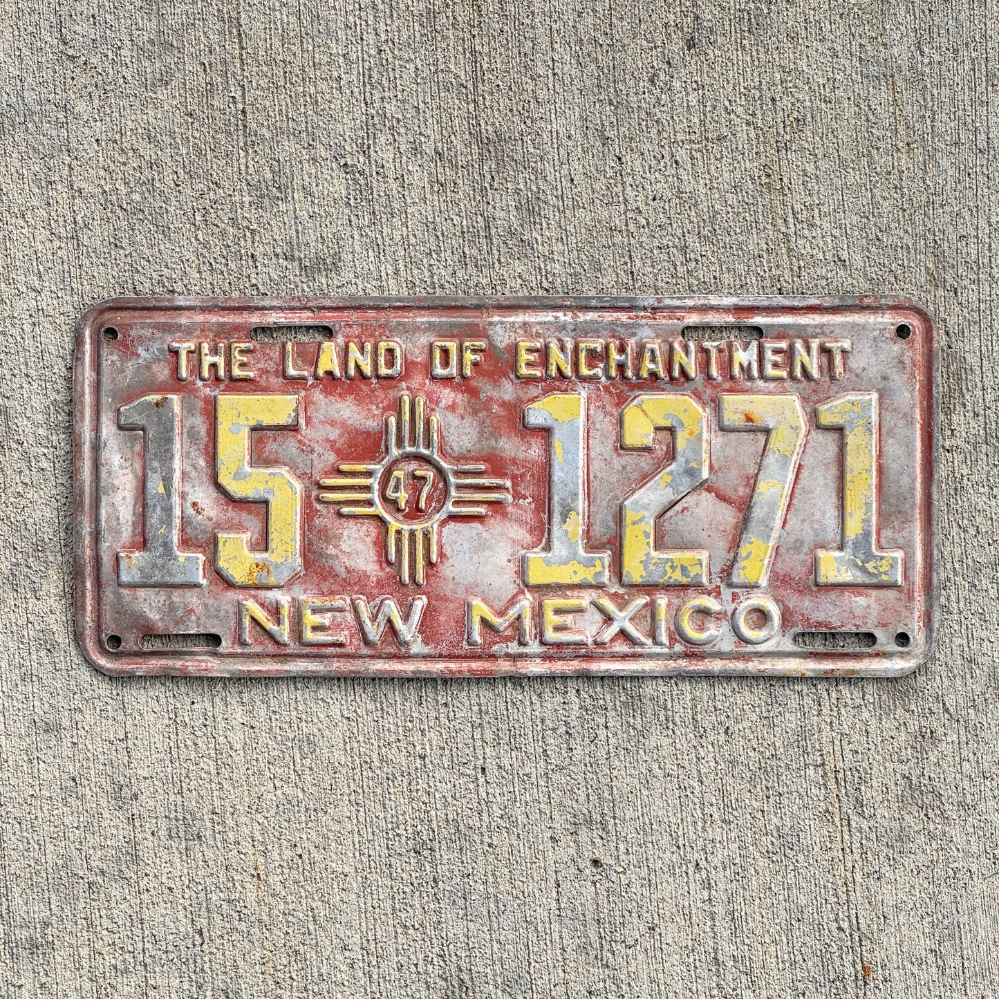 Photo of a 1947 New Mexico License Plate Auto Tag Garage Decor Vintage Iconic Zia Logo 15 1271 with original patina