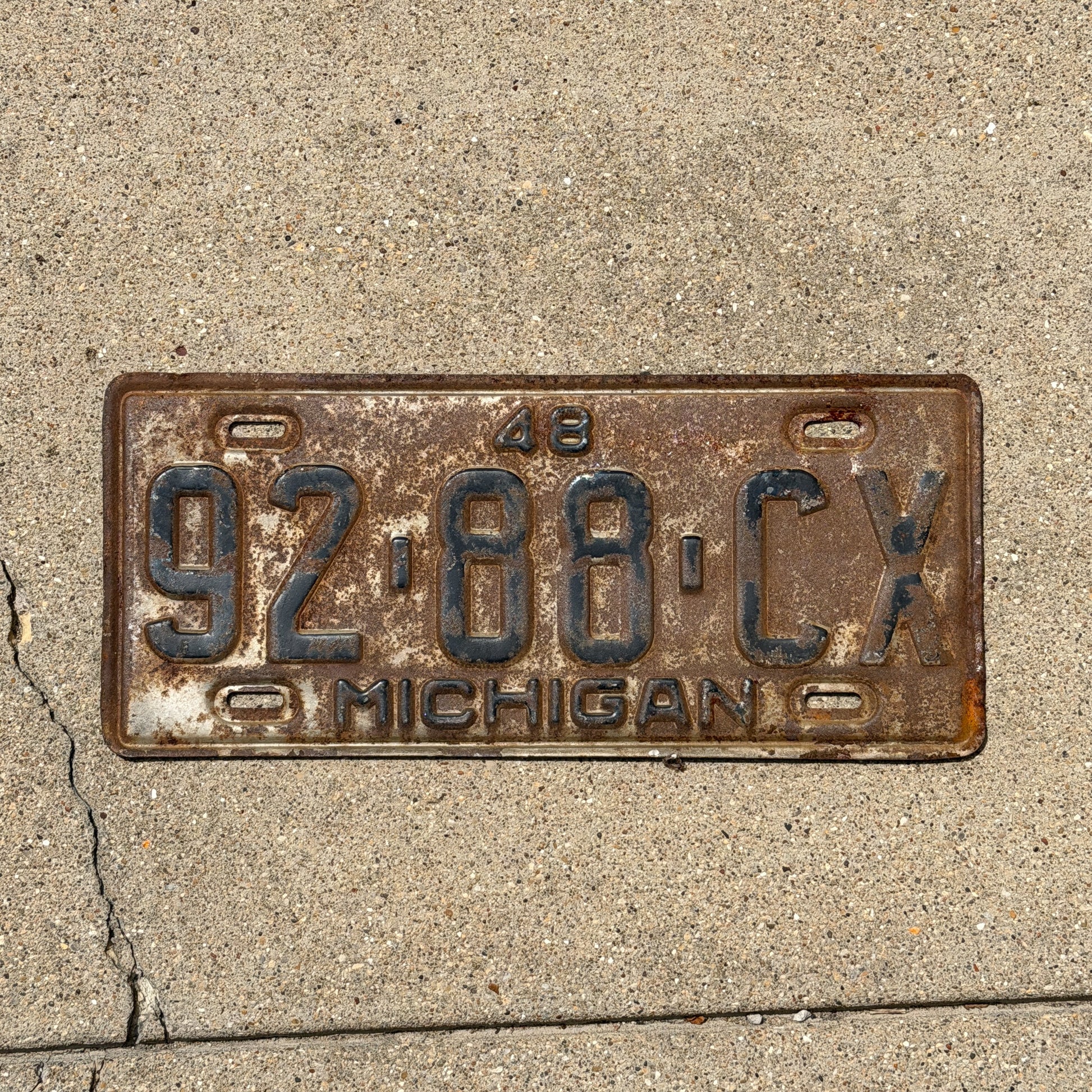 Photo of a 1948 Michigan Commercial License Plate Auto Tag Garage Decor Vintage 92 88 CX with original patina