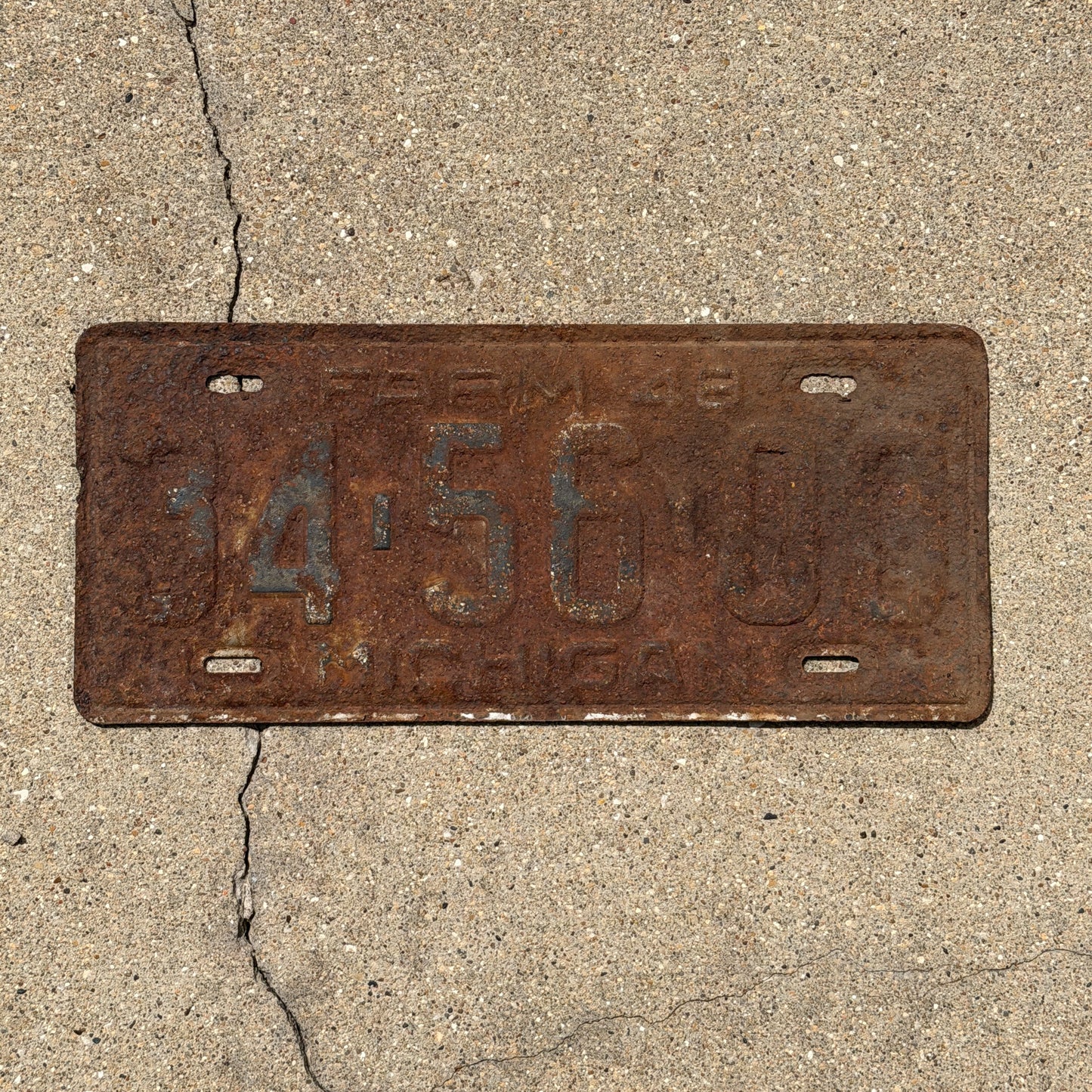 Photo of a 1948 Michigan Farm License Plate Auto Tag Garage Decor Vintage 34 56 00 with original patina