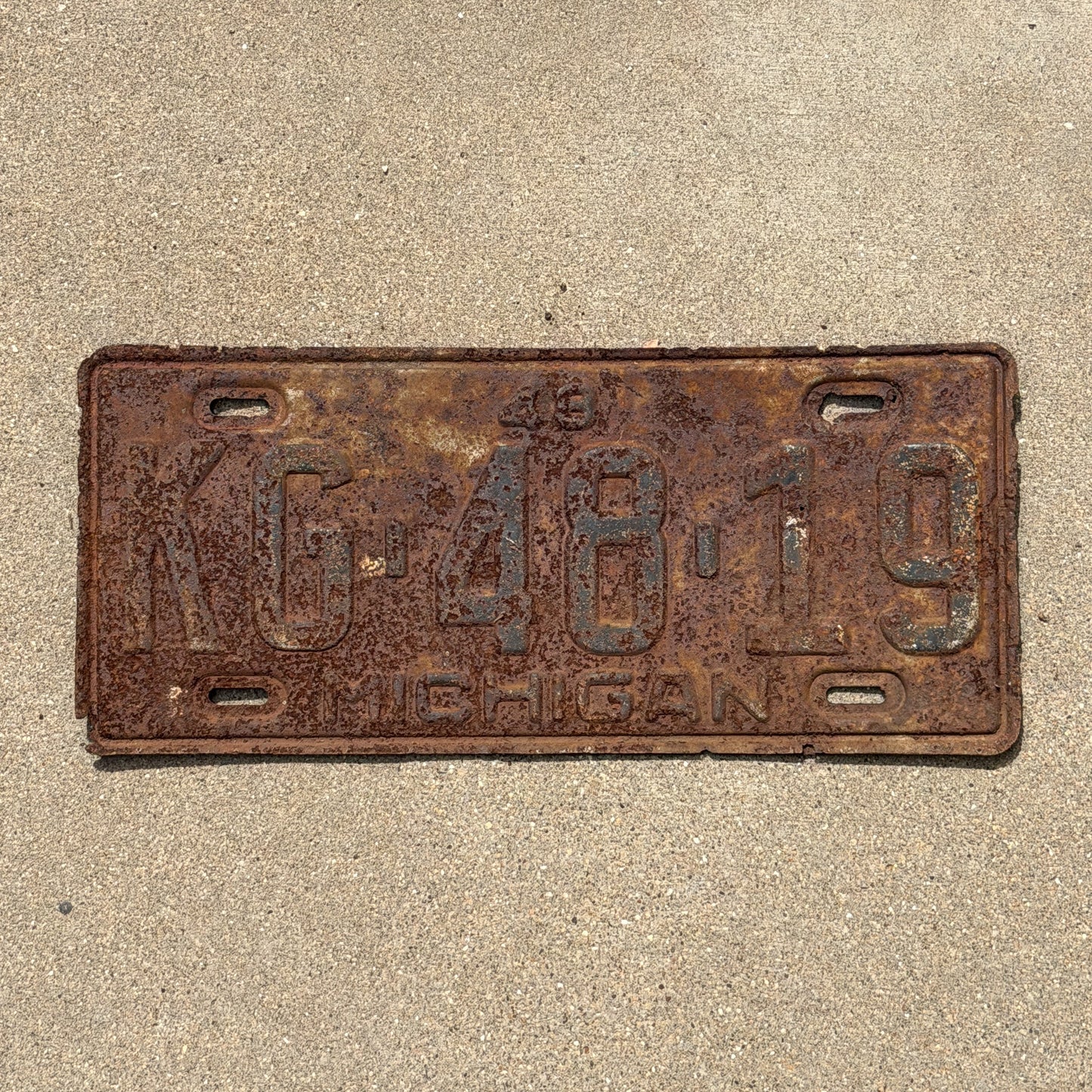 Photo of a 1948 Michigan License Plate Auto Tag Garage Decor Vintage KG 48 19 with original patina