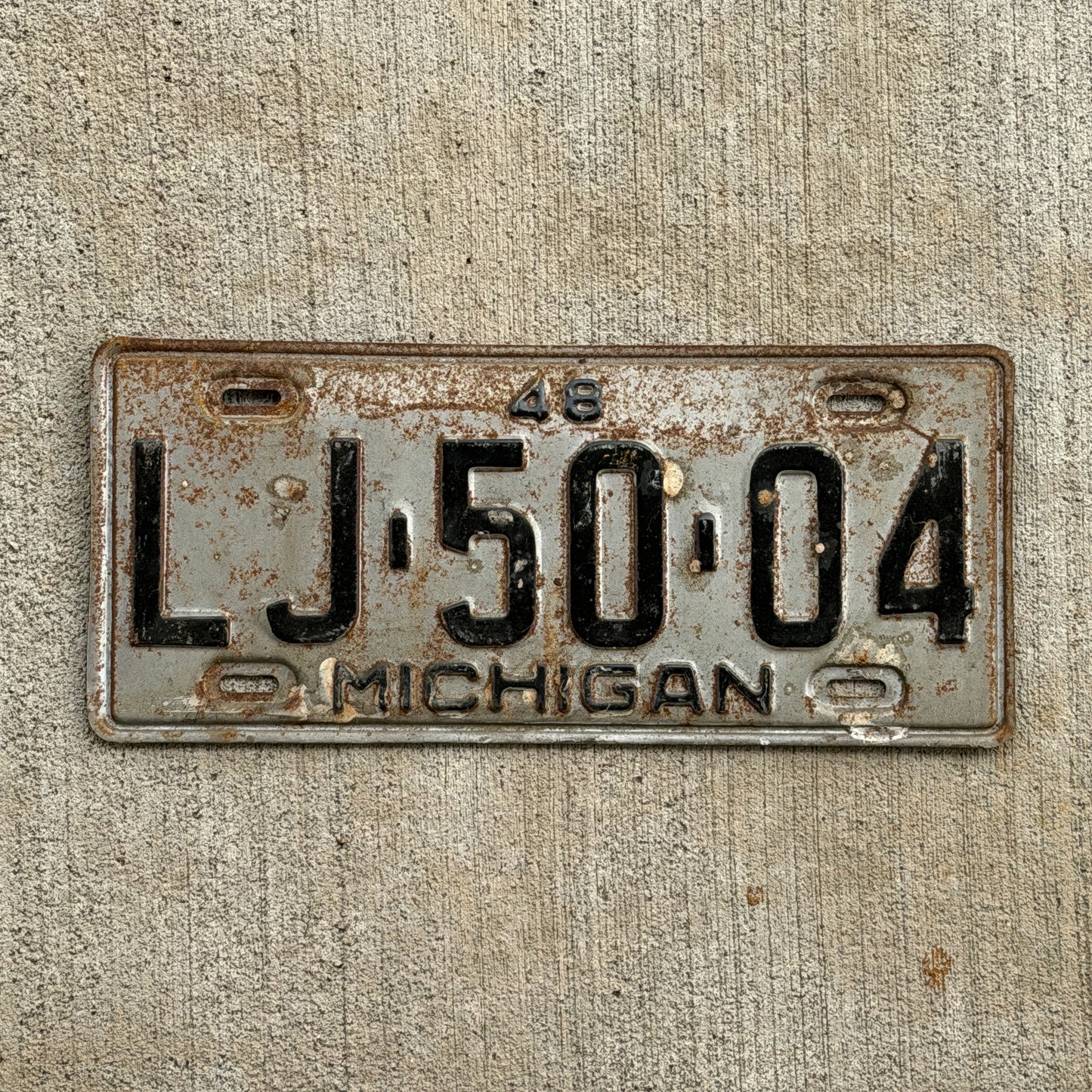 Photo of a 1948 Michigan License Plate Auto Tag Garage Decor Vintage LJ 50 04 with original patina