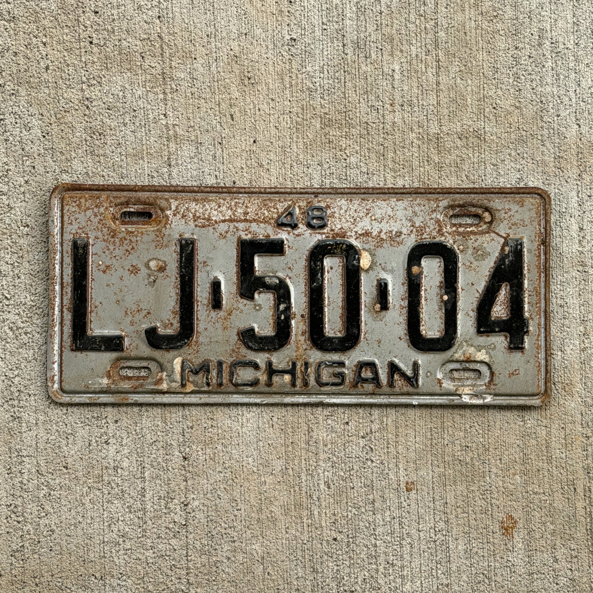 Photo of a 1948 Michigan License Plate Auto Tag Garage Decor Vintage LJ 50 04 with original patina