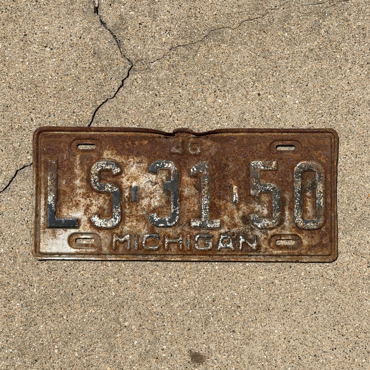 Photo of a 1948 Michigan License Plate Auto Tag Garage Decor Vintage LS 31 50 with original patina