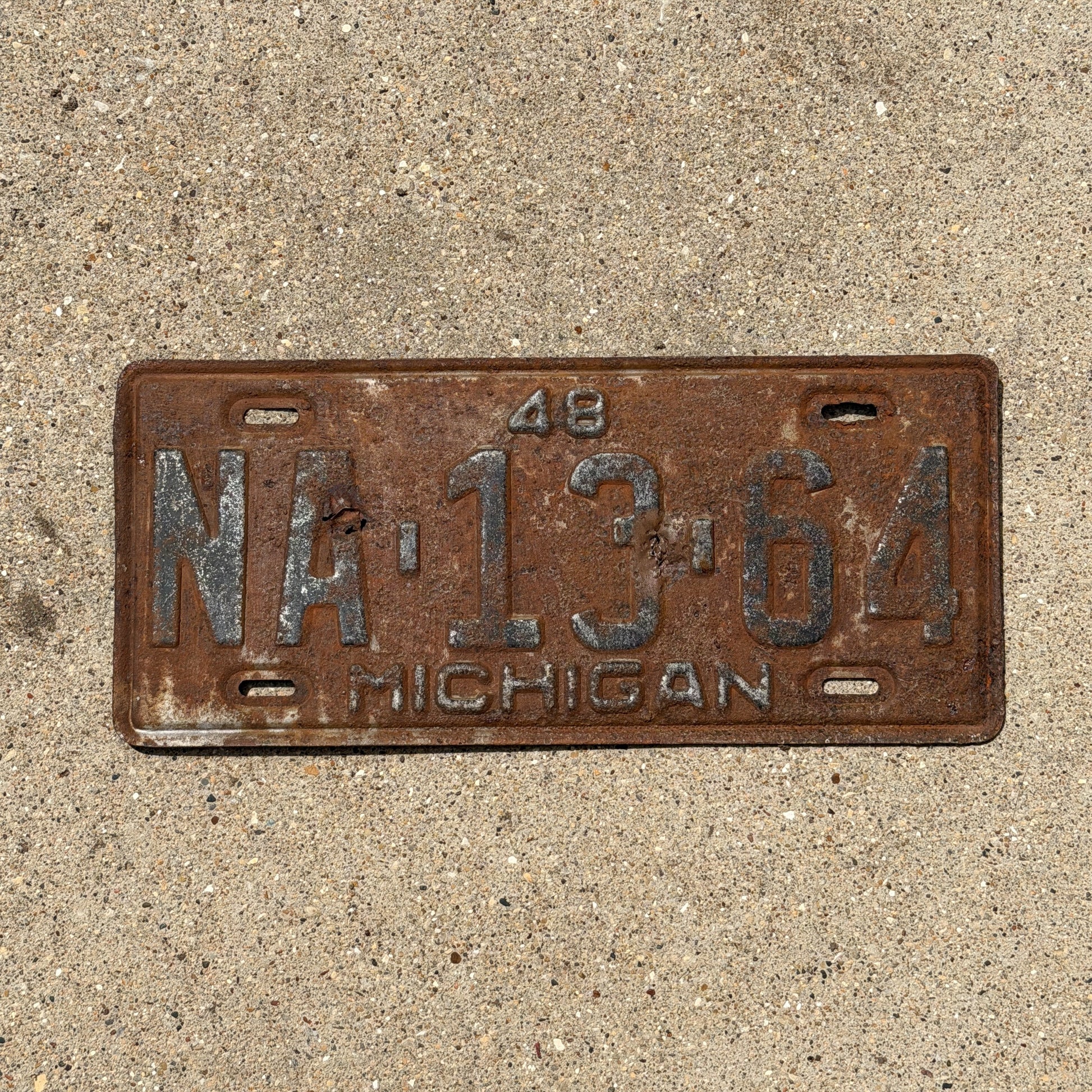 Photo of a 1948 Michigan License Plate Auto Tag Garage Decor Vintage NA 13 64 with original patina
