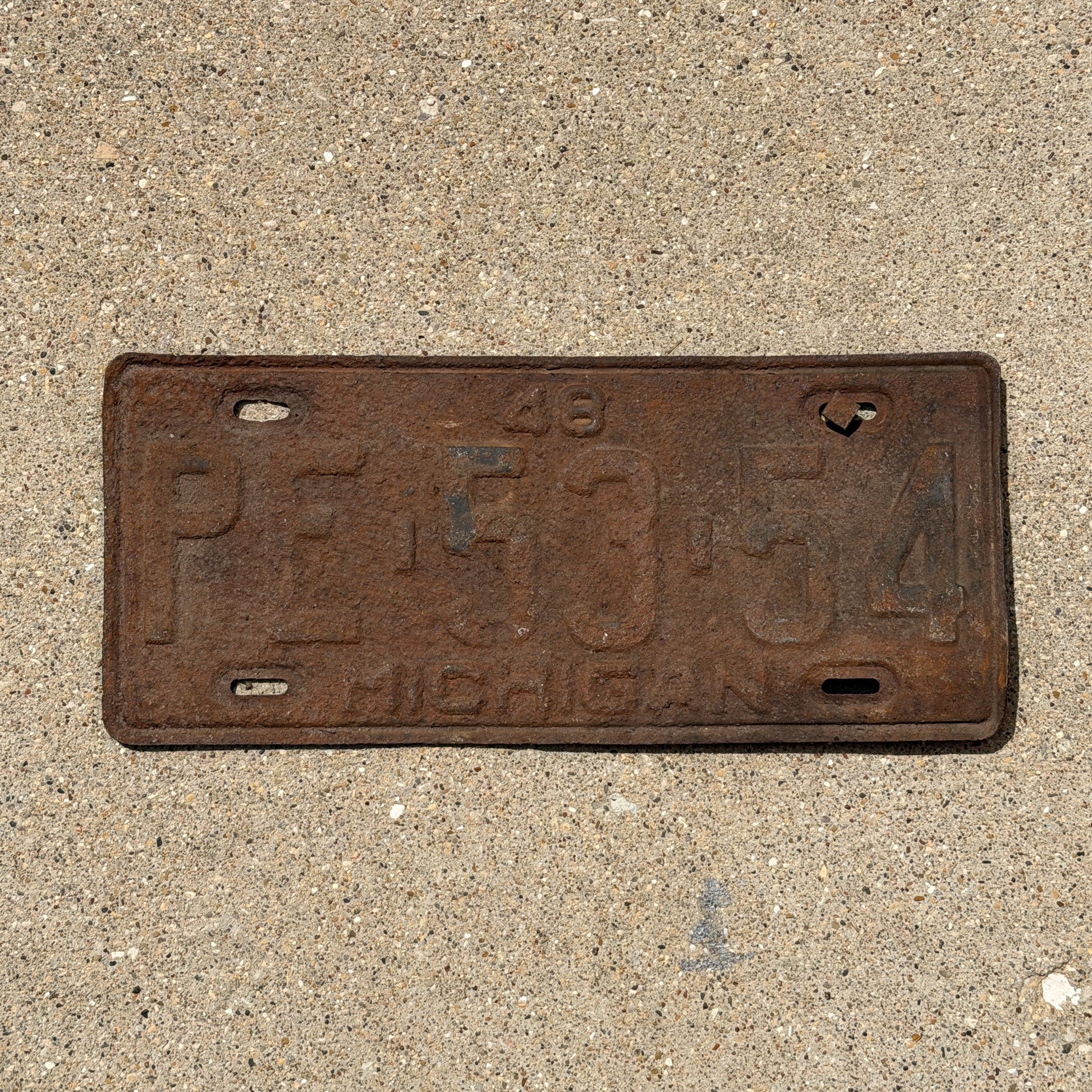 Photo of a 1948 Michigan License Plate Auto Tag Garage Decor Vintage PE 53 54 with original patina