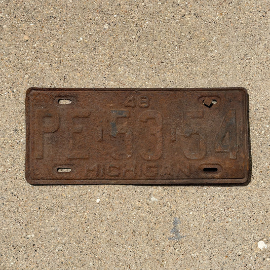 Photo of a 1948 Michigan License Plate Auto Tag Garage Decor Vintage PE 53 54 with original patina