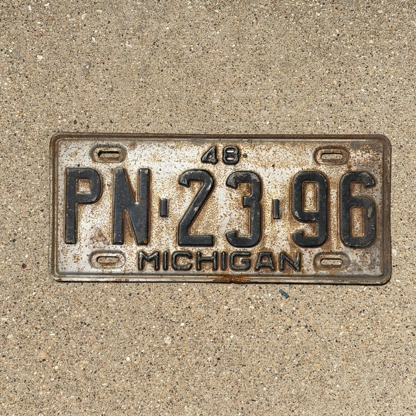 Photo of a 1948 Michigan License Plate Auto Tag Garage Decor Vintage PN 23 96 with original patina
