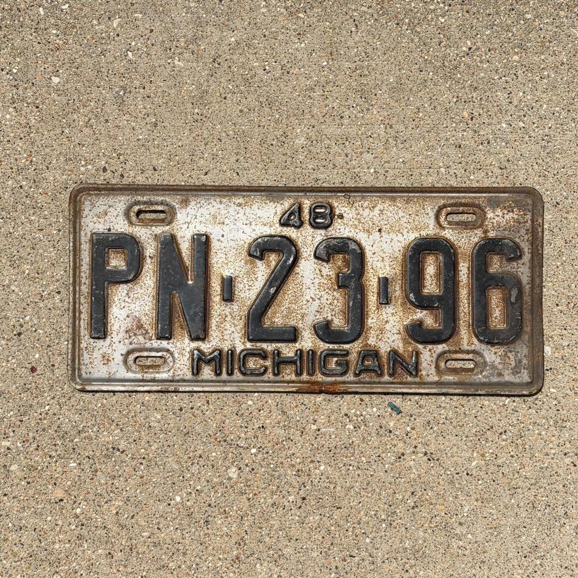 Photo of a 1948 Michigan License Plate Auto Tag Garage Decor Vintage PN 23 96 with original patina