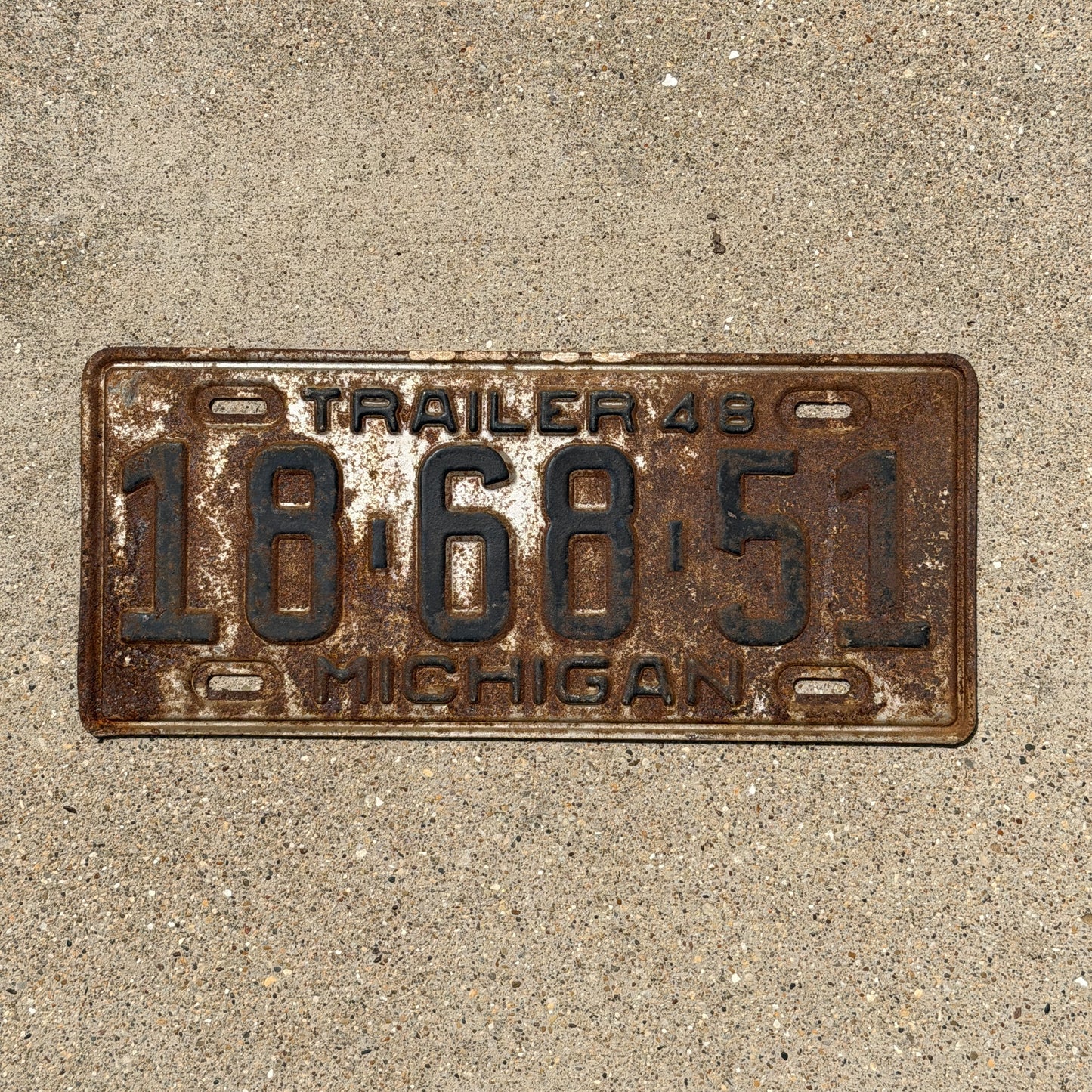 Photo of a 1948 Michigan Trailer License Plate Auto Tag Garage Decor Vintage 18 68 51 with original patina