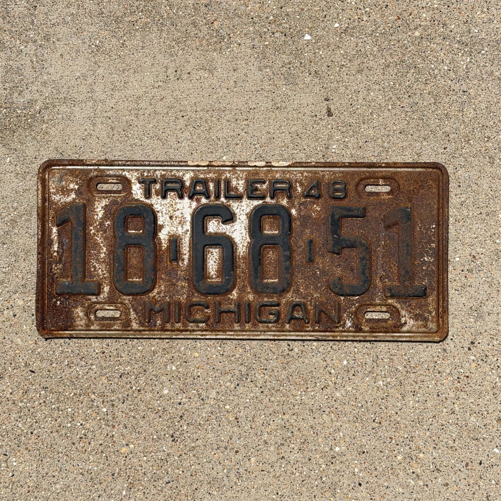 Photo of a 1948 Michigan Trailer License Plate Auto Tag Garage Decor Vintage 18 68 51 with original patina