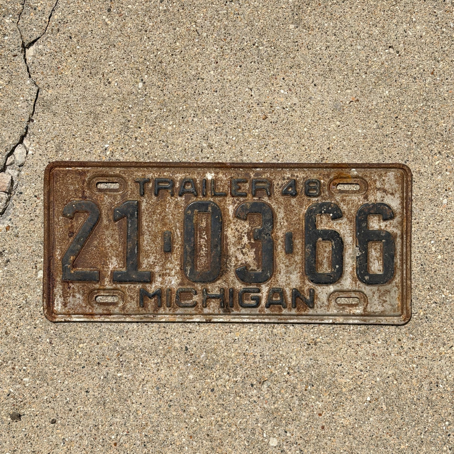 Photo of a 1948 Michigan Trailer License Plate Auto Tag Garage Decor Vintage 21 03 66 with original patina
