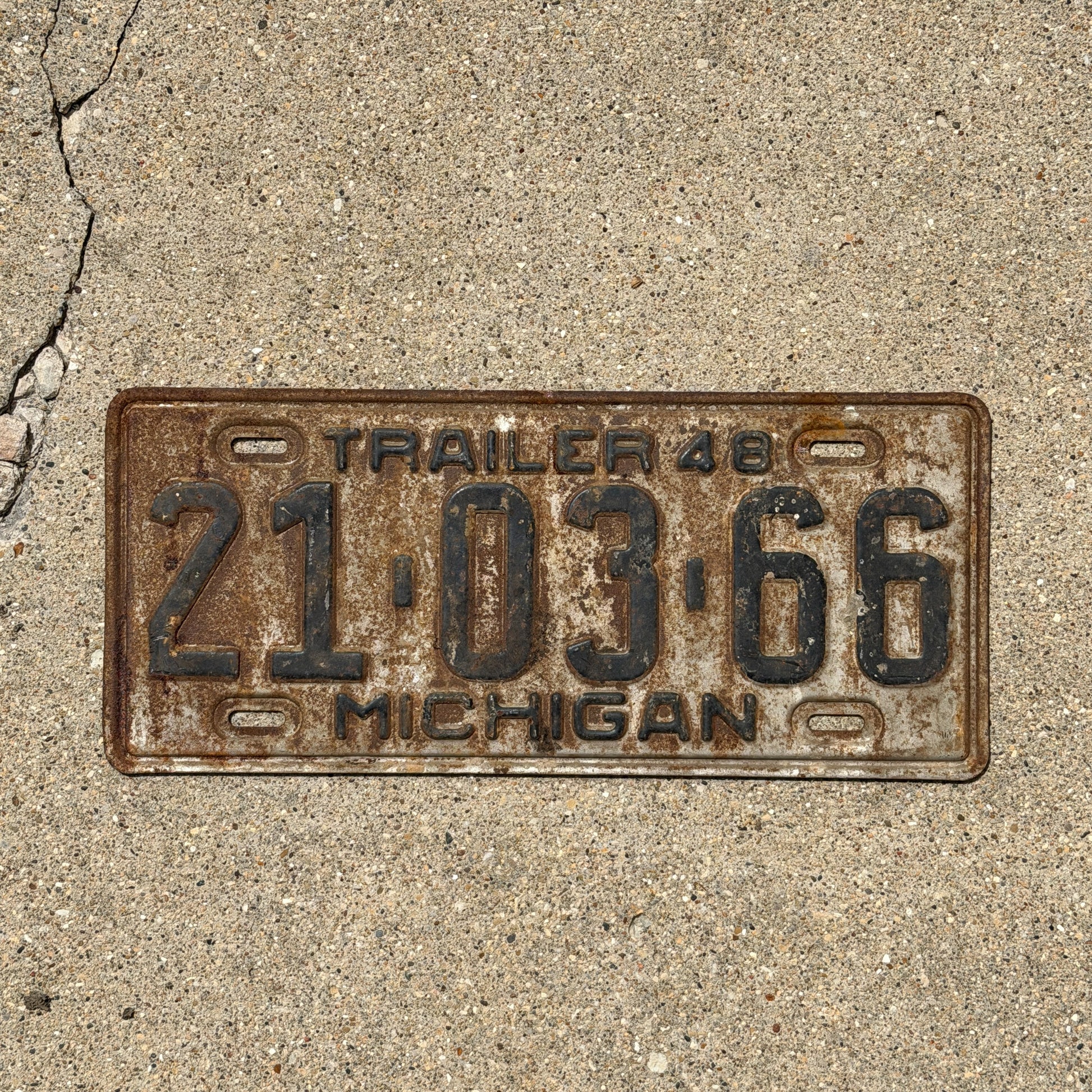 Photo of a 1948 Michigan Trailer License Plate Auto Tag Garage Decor Vintage 21 03 66 with original patina