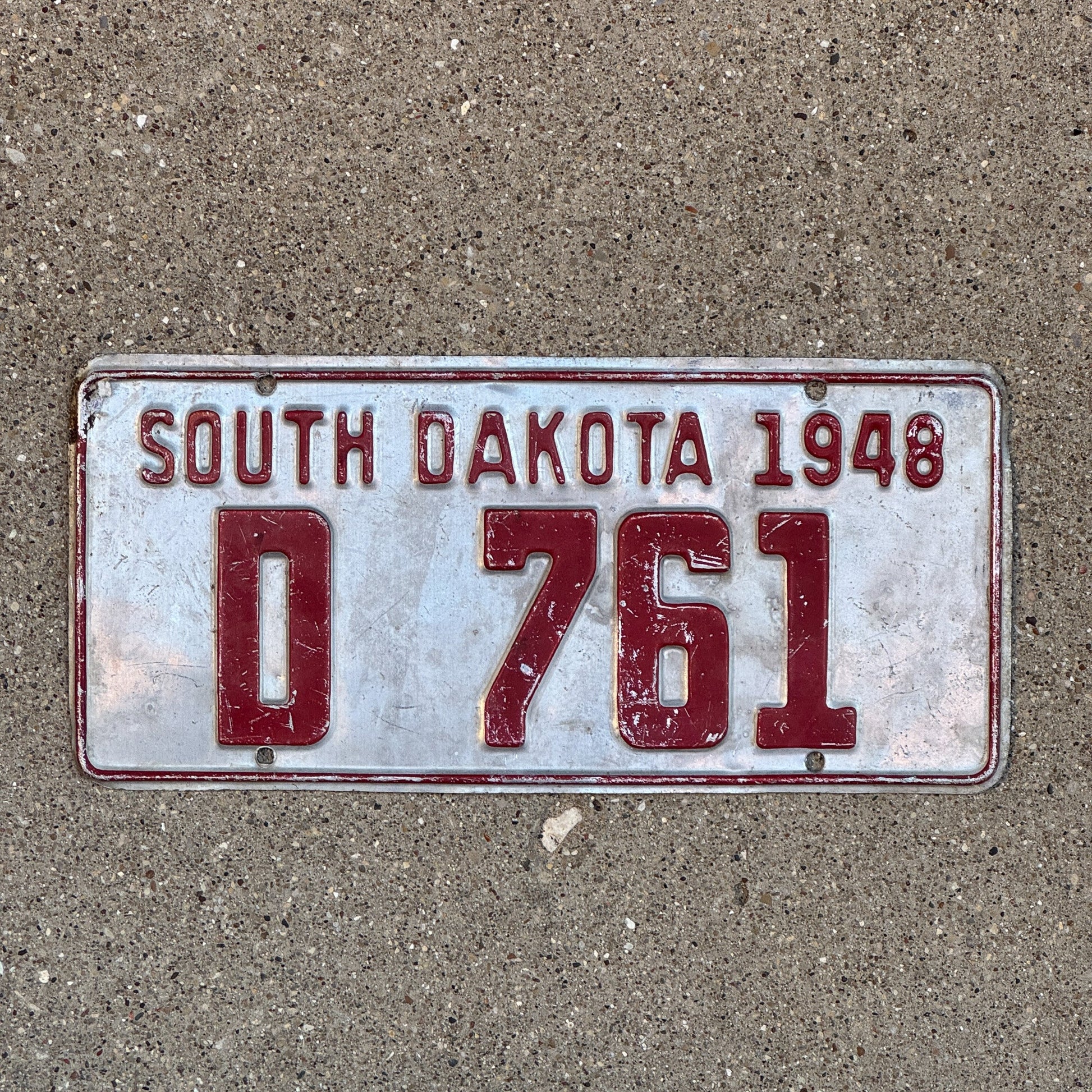 Photo of a 1948 South Dakota Dealer License Plate Auto Tag Garage Decor Vintage D 761 with original patina
