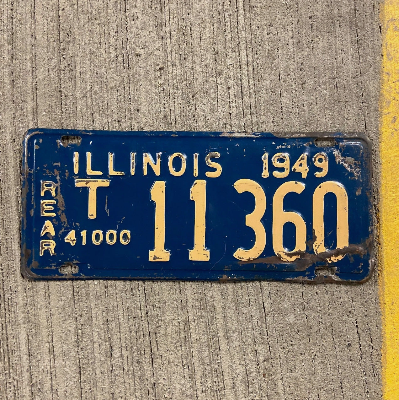 Photo of a 1949 Illinois Truck Mileage Tax License Plate Auto Tag Garage Decor Vintage Rear T 11360 with original patina