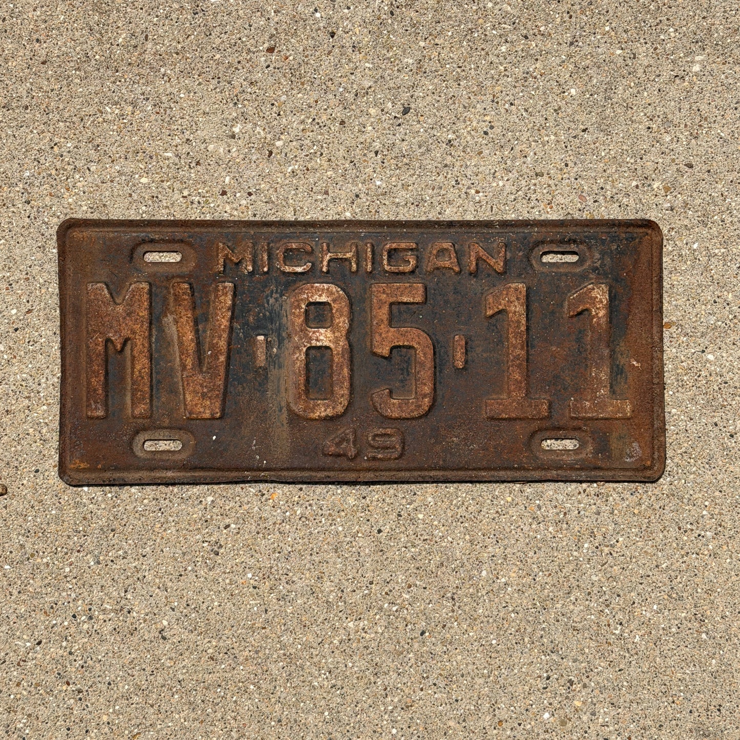 Photo of a 1949 Michigan License Plate Auto Tag Garage Decor Vintage MV 85 11 with original patina