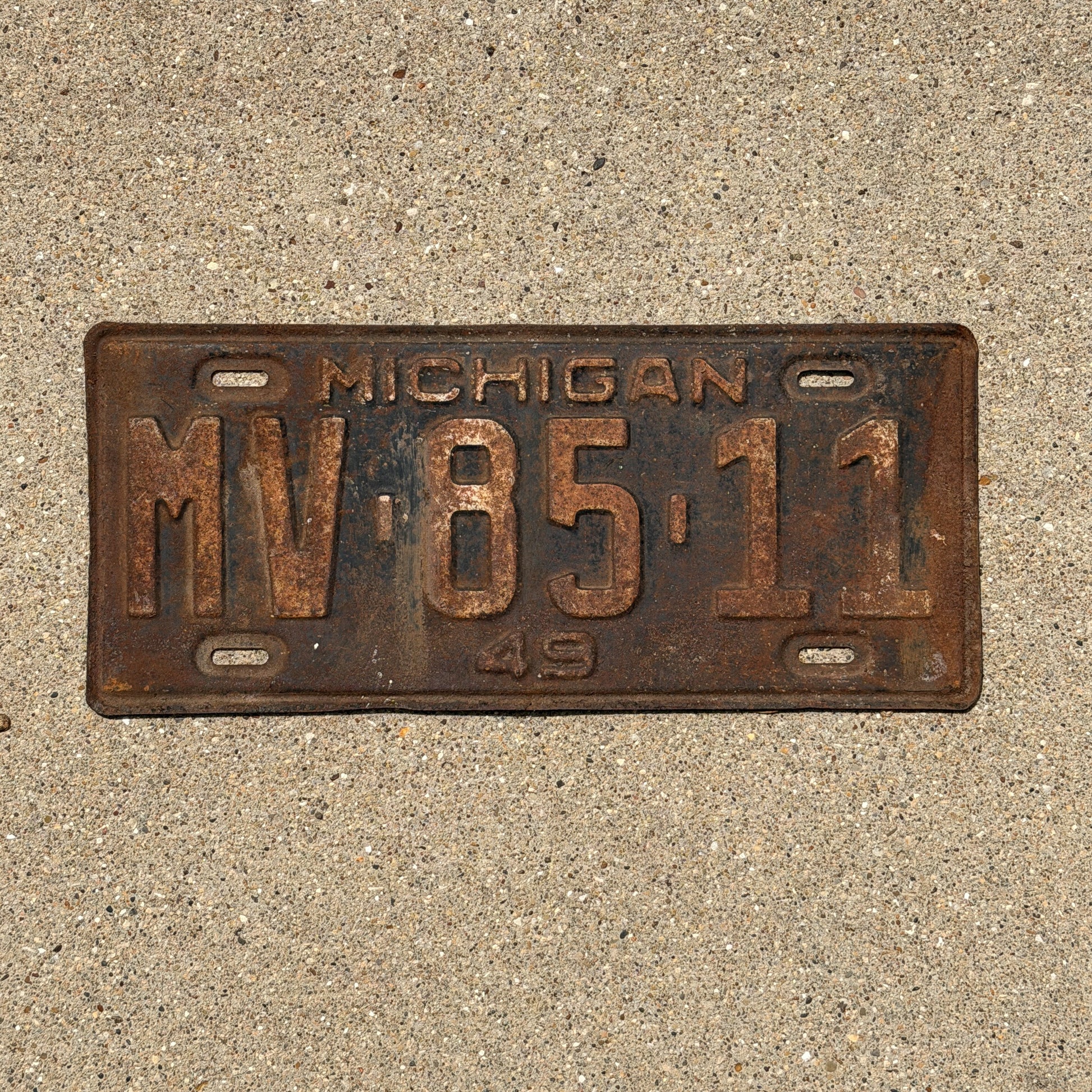 Photo of a 1949 Michigan License Plate Auto Tag Garage Decor Vintage MV 85 11 with original patina
