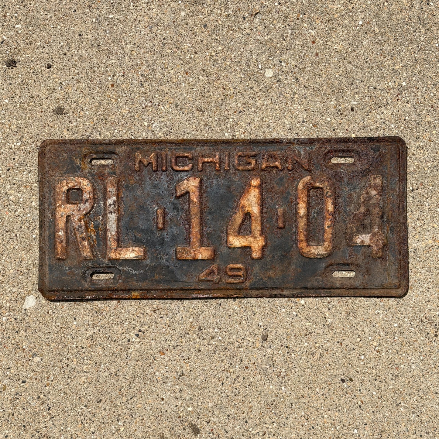 Photo of a 1949 Michigan License Plate Auto Tag Garage Decor Vintage RL 14 04 with original patina