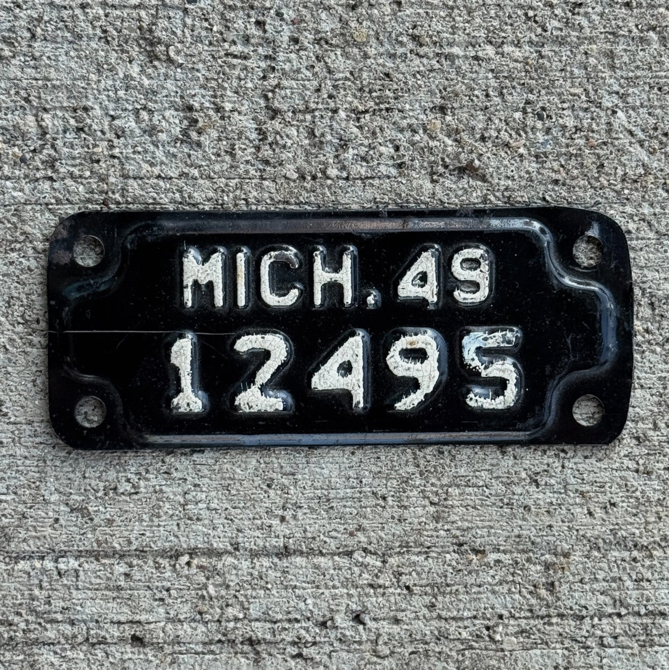 Photo of a 1949 Michigan Motorcycle License Plate Auto Tag Garage Decor Vintage 12495 with original patina