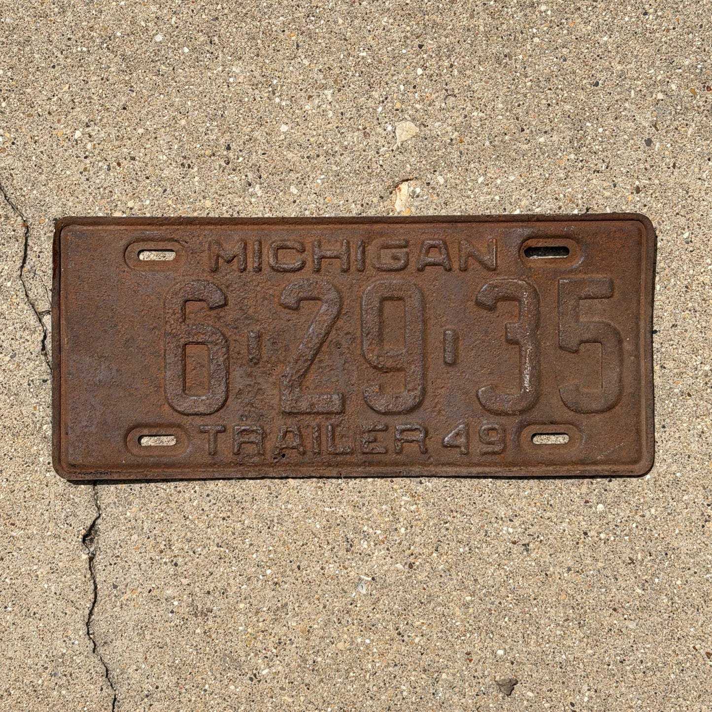 Photo of a 1949 Michigan Trailer License Plate Auto Tag Garage Decor Vintage 6 29 35 with original patina