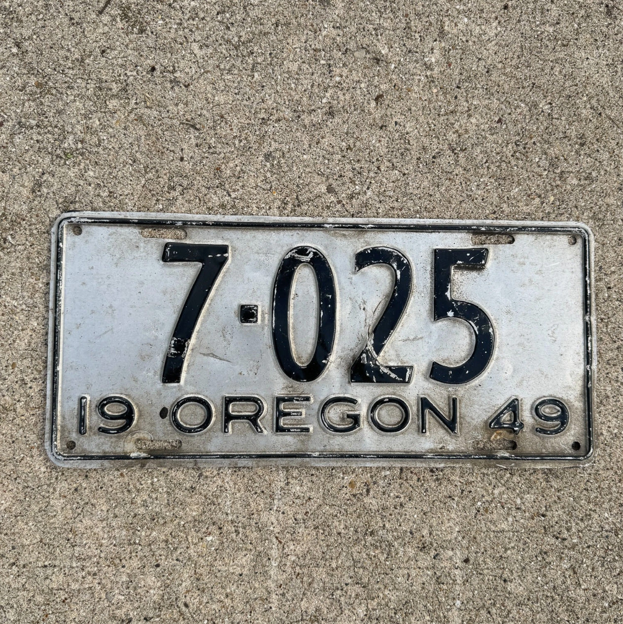 Photo of a 1949 Oregon License Plate Auto Tag Garage Decor Vintage Low Number Four Digit 7025 with original patina