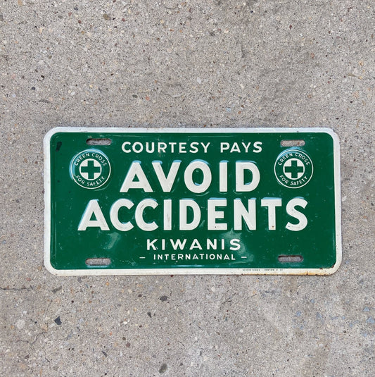 Photo of a 1950 Era Avoid Accidents Booster License Plate Auto Tag 1 Vintage Garage Kiwanis Green Cross with original patina