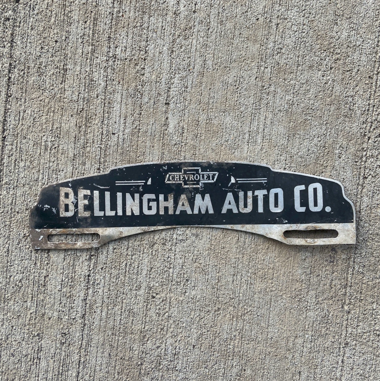 Photo of a 1950 Era Bellingham Wisconsin License Plate Topper Auto Tag Garage Decor Vintage Chevy Dealer Auto Co with original patina