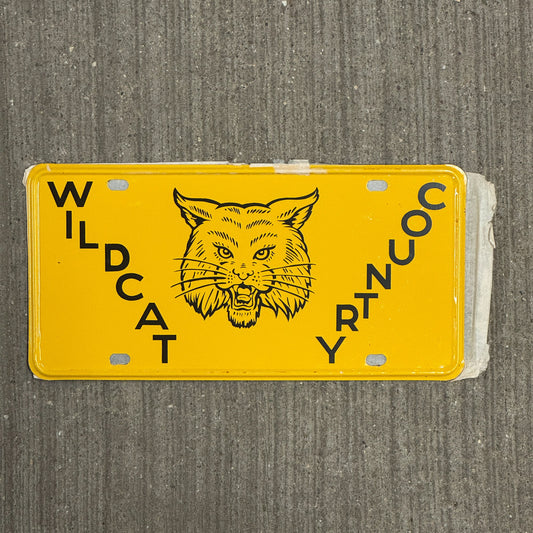 Photo of a 1950 Era Booster License Plate Auto Tag 11 Garage Decor New Old Stock with Rice Paper Wildcat Country with original patina