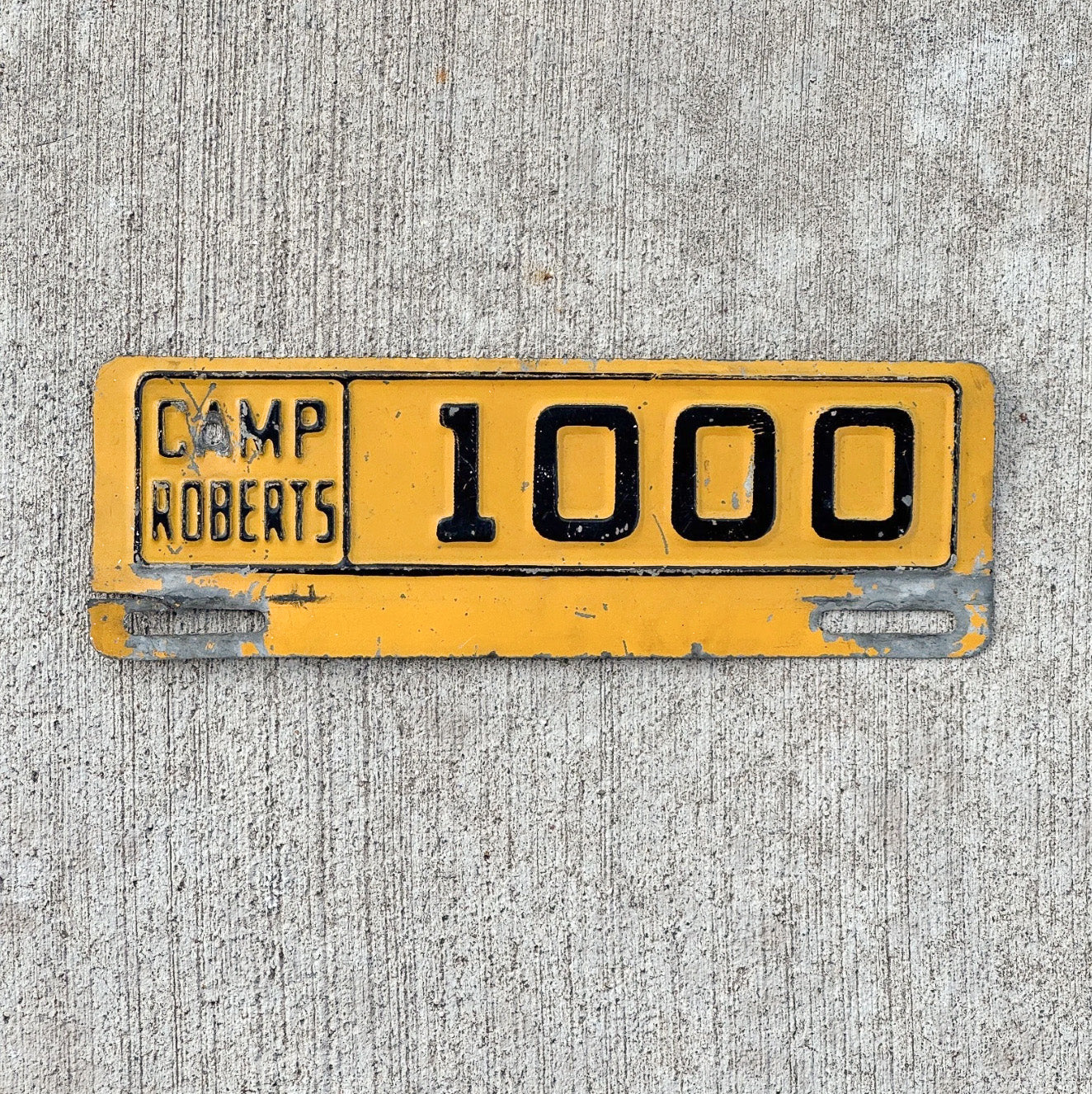 Photo of a 1950 Era Camp Roberts California License Plate Topper Auto Tag Garage Decor Vintage Military National Guard 1000 with original patina