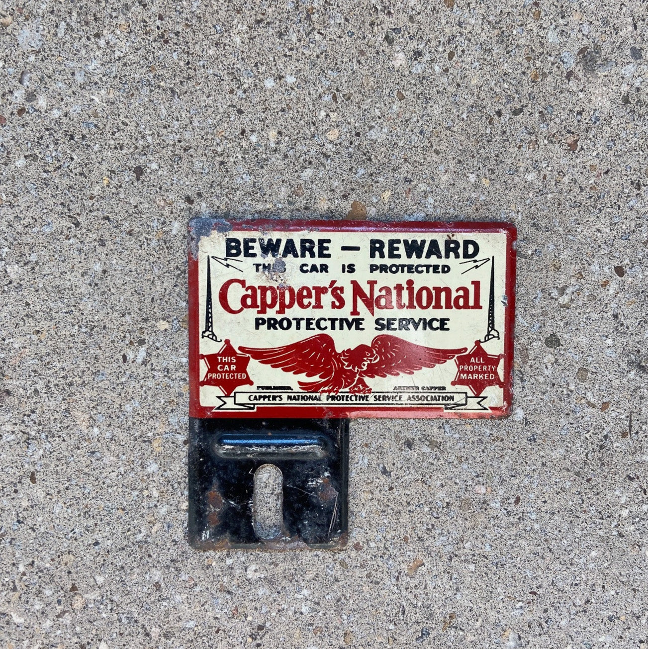 Photo of a 1950 Era Capper's National Insurance License Plate Topper Auto Tag Garage Decor Vintage Protected Eagle Small with original patina