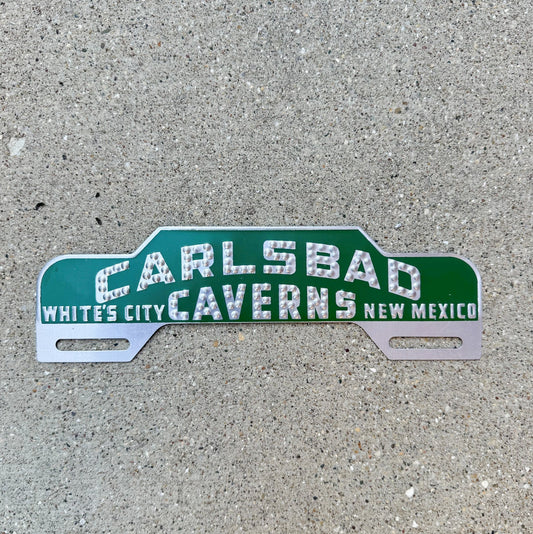 Photo of a 1950 Era Carlsbad Caverns New Mexico License Plate Topper Auto Tag Garage Decor Vintage White's City Green with original patina