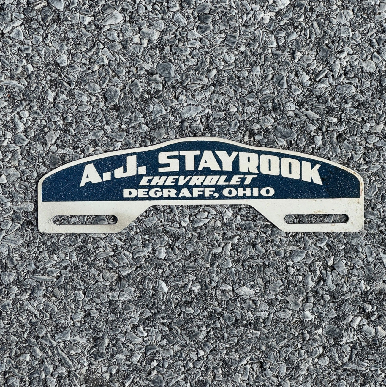 Photo of a 1950 Era De Graff Ohio License Plate Topper Auto Classic Car Dealer Stayrook Chevy with original patina
