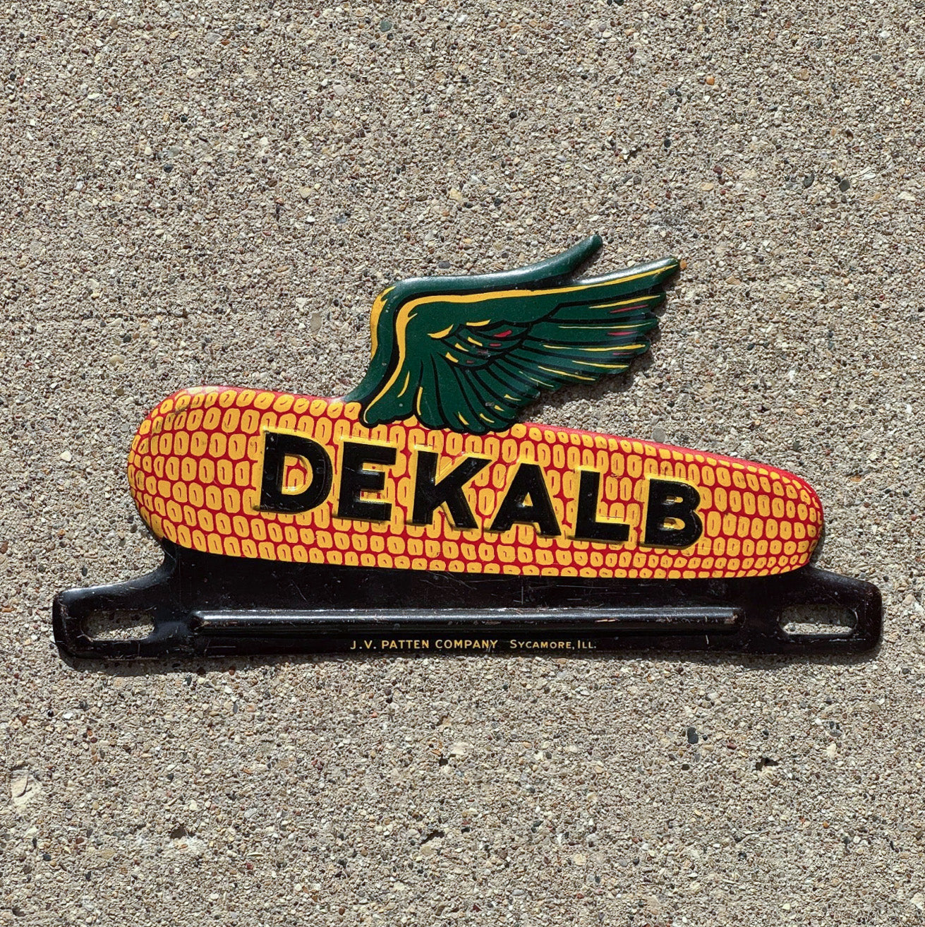 Photo of a 1950 Era DeKalb Corn License Plate Topper Auto Tag Garage Decor Vintage Seed Advertising Farm Farming Ear Cob with original patina