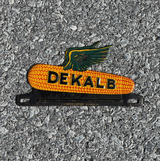 Photo of a 1950 Era DeKalb Corn License Plate Topper Auto Tag Garage Seed Advertising Farm Farming Ear Cob with original patina