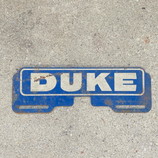 Photo of a 1950 Era Duke Blue Devils North Carolina License Plate Topper Auto Tag Garage Decor Vintage Reflective Durham North Carolina University with original patina
