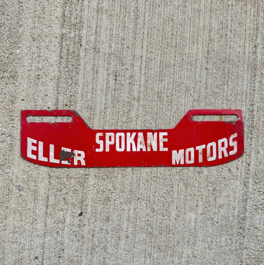 Photo of a 1950 Era Eller Motors Spokane Washington License Plate Topper Auto Tag Garage Decor Vintage Auto Dealer Garage with original patina
