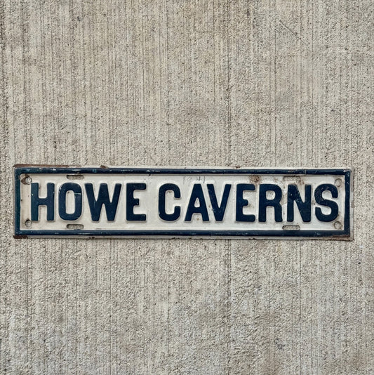 Photo of a 1950 Era Howe Caverns New York License Plate Topper Auto Tag Garage Decor Vintage Embossed Black Gray Upstate with original patina