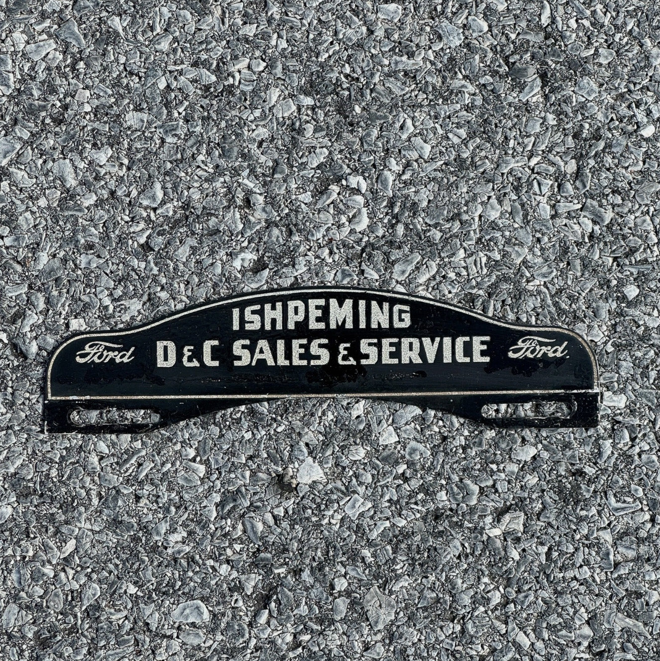 Photo of a 1950 Era Ishpeming Michigan License Plate Topper Auto Ford Dealer Smaltz Paint with original patina