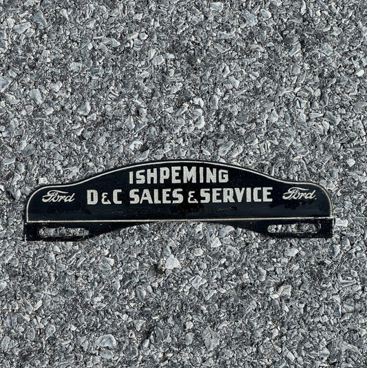 Photo of a 1950 Era Ishpeming Michigan License Plate Topper Auto Ford Dealer Smaltz Paint with original patina